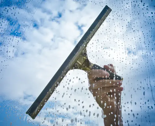 Exterior window being cleaned with a squeegee